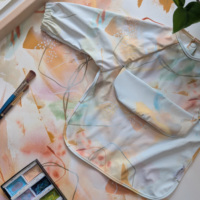 Bavette à manches longues avec pochette intégrée