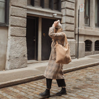 femme qui porte un sac fourre-tout en sherpa  beige dans la ville de Montréal