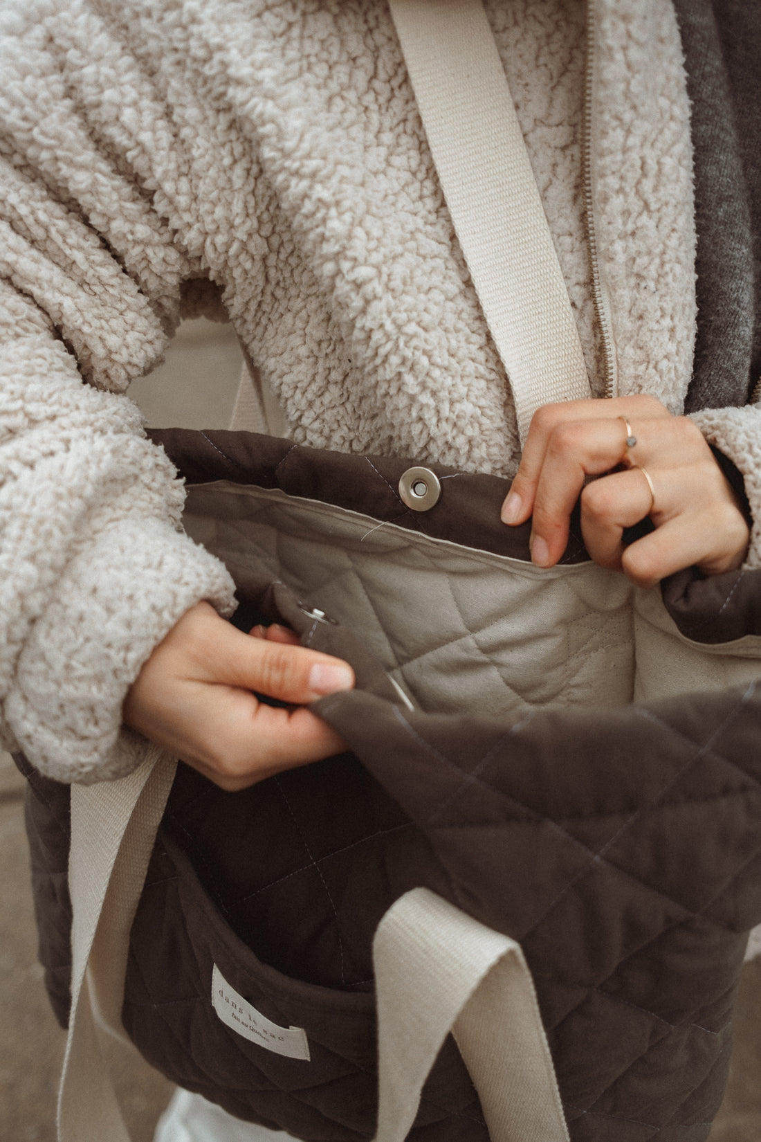 femme refermant le sac fourre-tout avec la fermeture aimantée